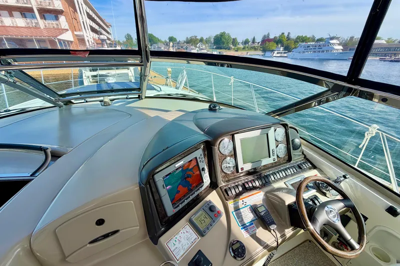 Slide: The Image of Helm of 2008 Sea Ray 44 Sundancer yacht with navigation equipment and waterfront view. - 15