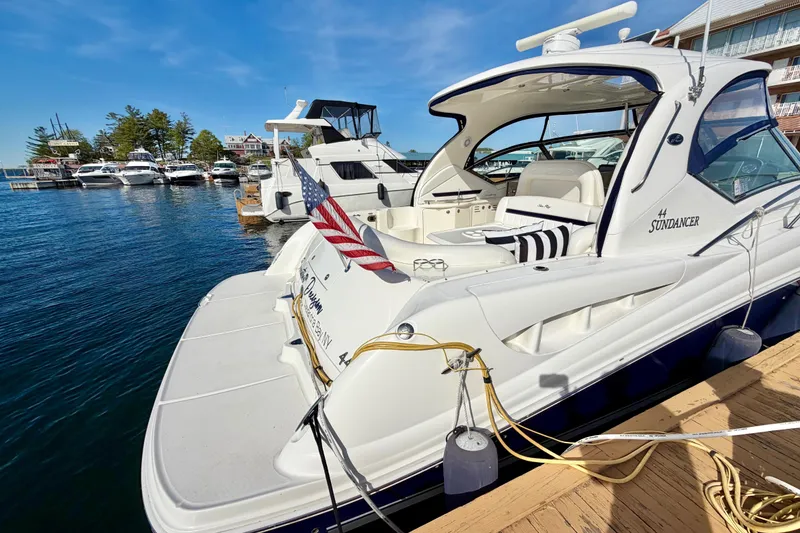 Slide: The Image of 2008 Sea Ray 44 Sundancer yacht docked at marina with American flag. - 2