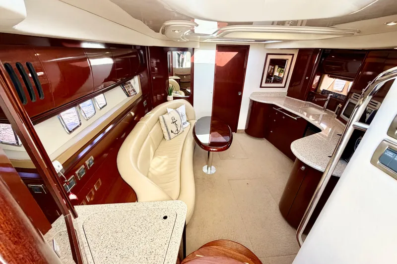 Slide: The Image of Luxurious interior of 2008 Sea Ray 44 Sundancer yacht with elegant seating and modern kitchen. - 21