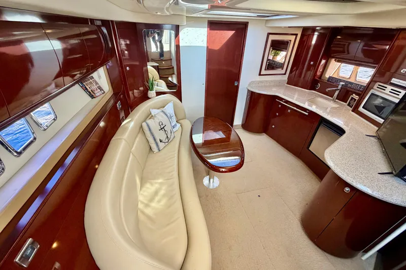 Slide: The Image of Luxurious interior of 2008 Sea Ray 44 Sundancer yacht with elegant seating and modern kitchen. - 24