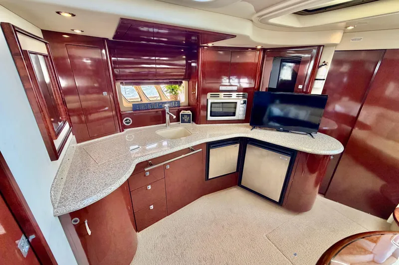 Slide: The Image of Luxurious 2008 Sea Ray 44 Sundancer yacht interior with modern kitchen and entertainment area. - 26