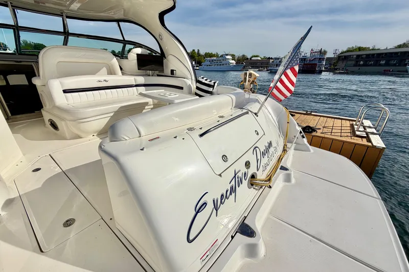 Slide: The Image of 2008 Sea Ray 44 Sundancer yacht docked, featuring luxurious seating and American flag. - 3