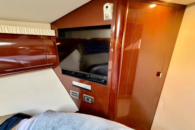 Slide: The Image of Interior of 2008 Sea Ray 44 Sundancer with TV and wooden cabinetry. - 32