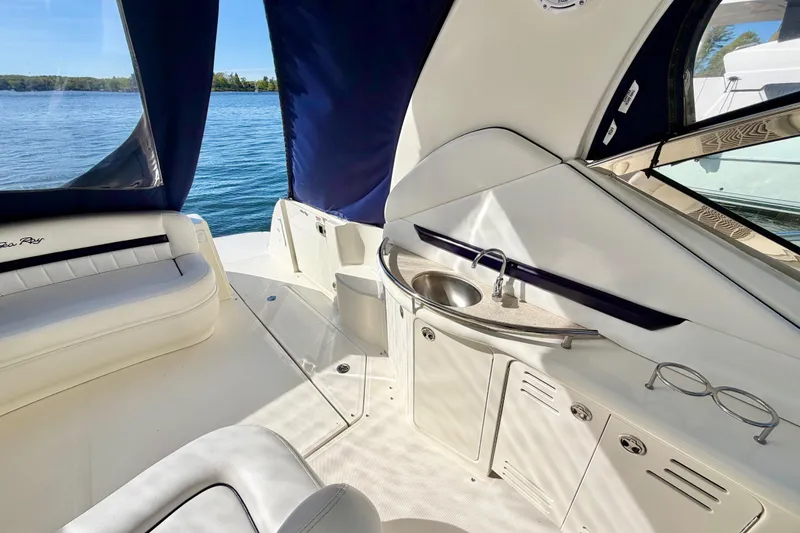 Slide: The Image of 2008 Sea Ray 44 Sundancer yacht interior with seating and kitchenette, overlooking serene water. - 40