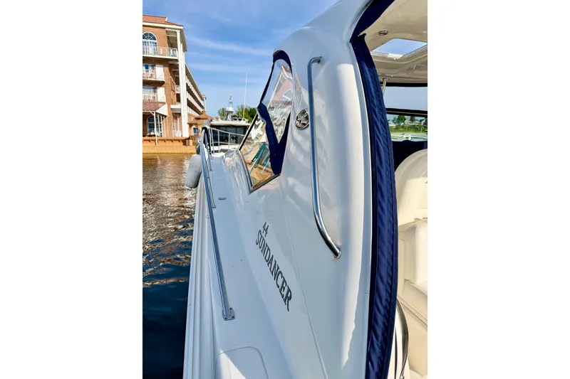 Slide: The Image of 2008 Sea Ray 44 Sundancer yacht docked near waterfront building. - 43