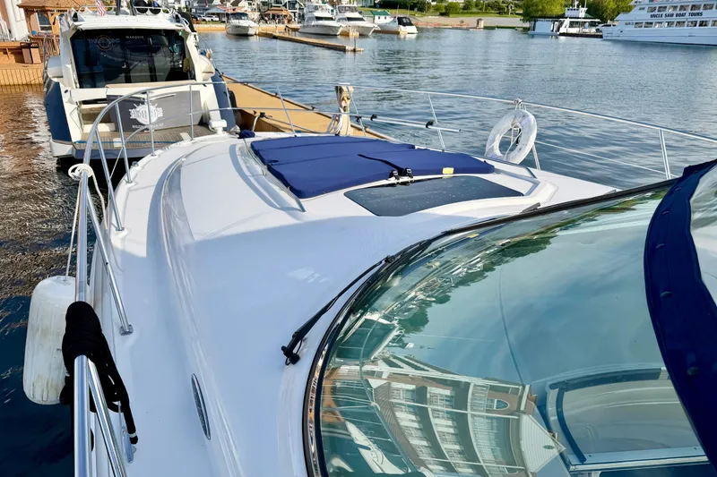 Slide: The Image of 2008 Sea Ray 44 Sundancer yacht docked at marina, featuring sleek design and spacious deck. - 44