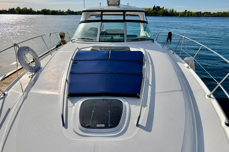 Slide: The Image of 2008 Sea Ray 44 Sundancer yacht on calm water, featuring a sleek deck design. - 48