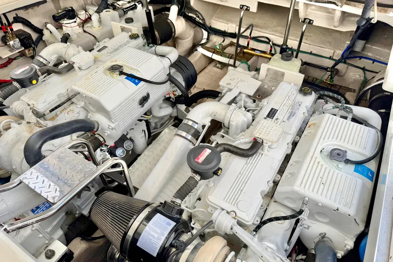 Slide: The Image of Engine room of a 2008 Sea Ray 44 Sundancer, showcasing dual marine engines. - 51