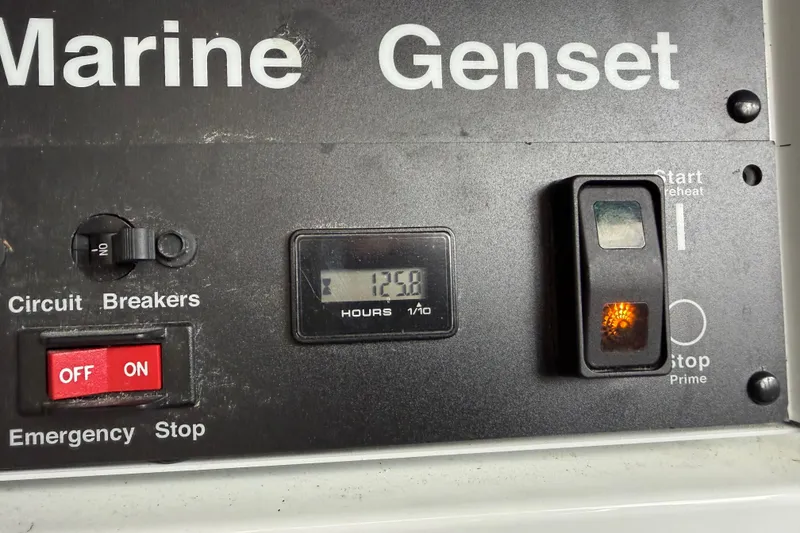 Slide: The Image of Marine genset control panel with hour meter reading 1250 on a 2008 Sea Ray 44 Sundancer. - 53