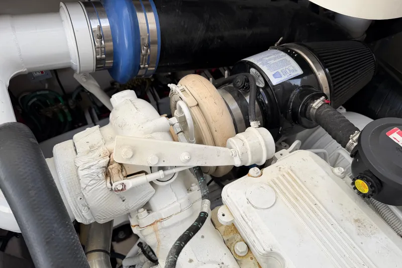 Slide: The Image of Engine components of a 2008 Sea Ray 44 Sundancer boat, featuring hoses and filters. - 54