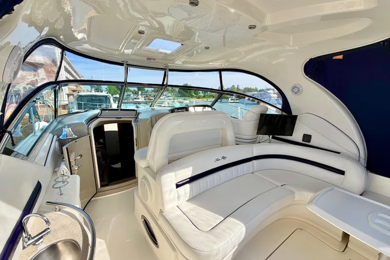 Slide: The Image of Luxurious interior of 2008 Sea Ray 44 Sundancer yacht with white seating and panoramic windows. - 9