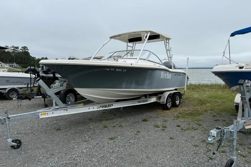 The Image of 2018 Key West 239 DFS boat on trailer near a lake, ready for transport. - 0