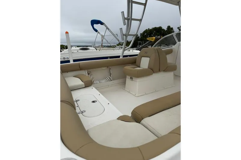 Slide: The Image of 2018 Key West 239 DFS boat interior with beige seating and open deck layout. - 2