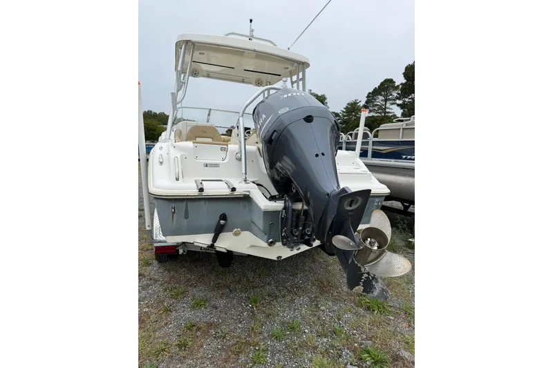 Slide: The Image of 2018 Key West 239 DFS boat with Yamaha outboard motor, parked on gravel. - 3