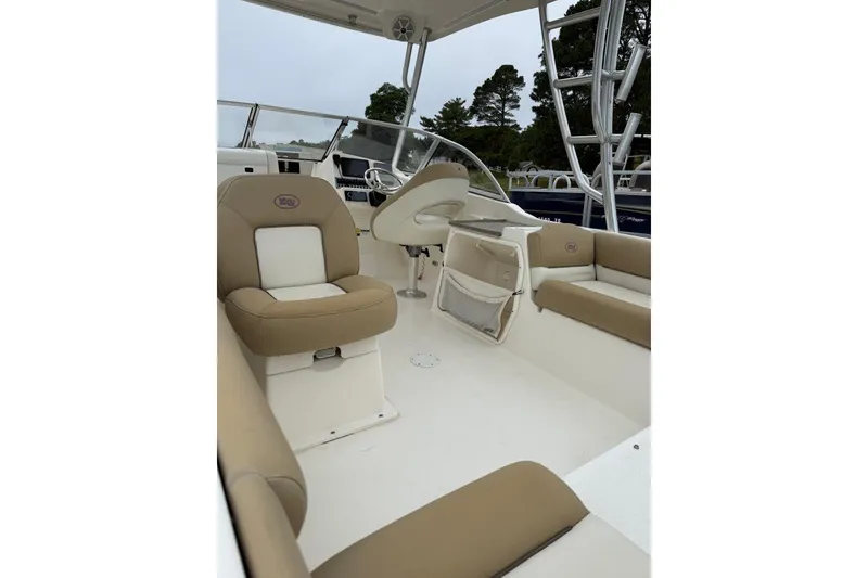 Slide: The Image of 2018 Key West 239 DFS boat interior with beige seating and steering console. - 4