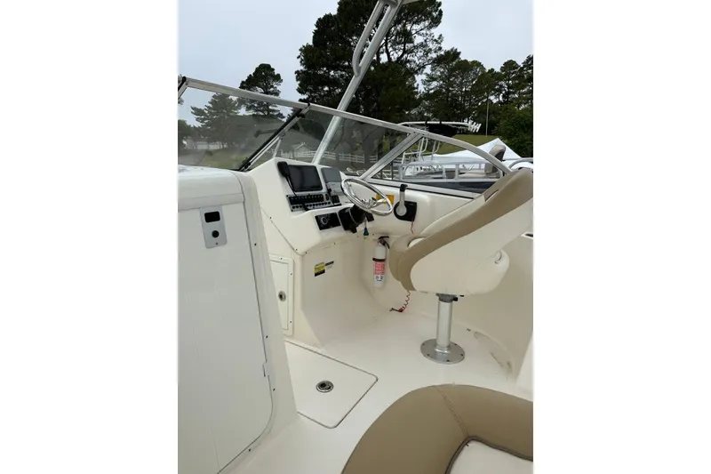 Slide: The Image of 2018 Key West 239 DFS boat interior with steering wheel and seating. - 5