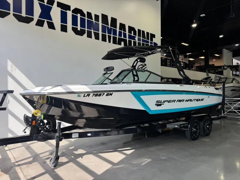 Slide: The Image of 2019 Nautique Super Air Nautique GS24 boat in showroom. - 2