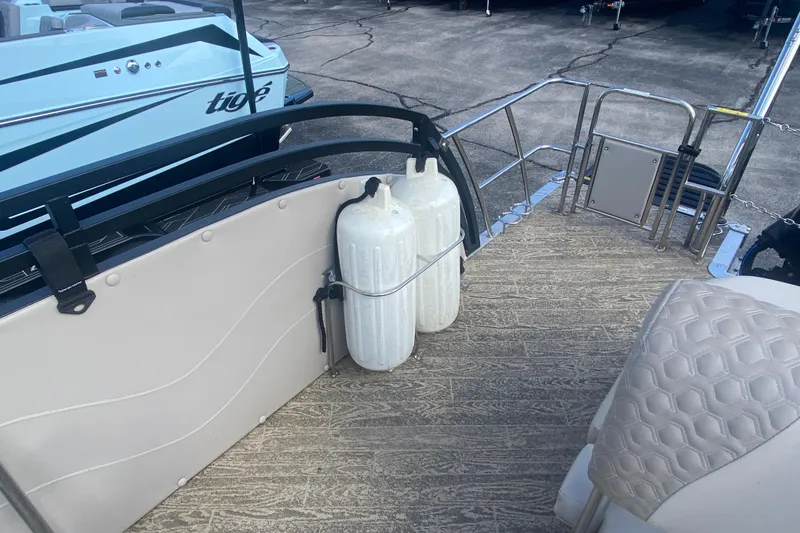 Slide: The Image of 2023 JC Swingback 27 TT Sport boat deck with propane tanks and seating. - 18