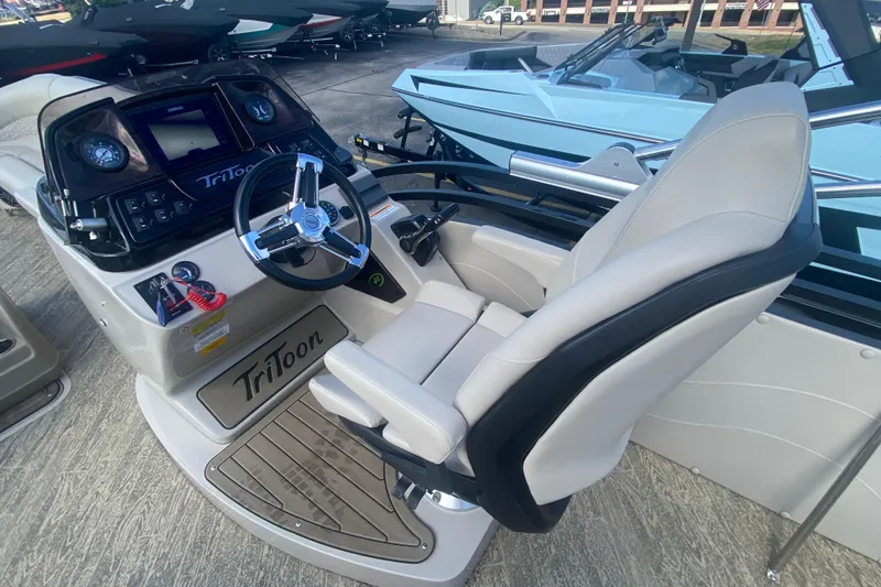 Slide: The Image of 2023 JC Swingback 27 TT Sport boat cockpit with steering wheel and control panel. - 19