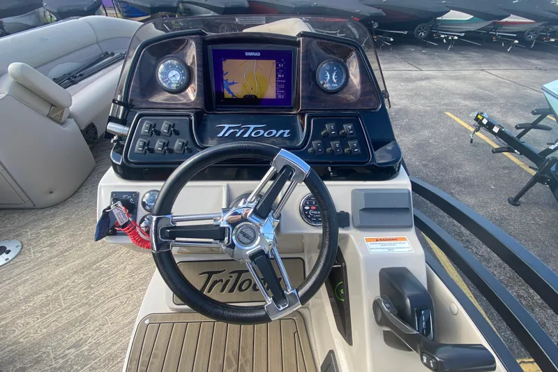 Slide: The Image of 2023 JC Swingback 27 TT Sport boat dashboard with steering wheel and navigation display. - 20