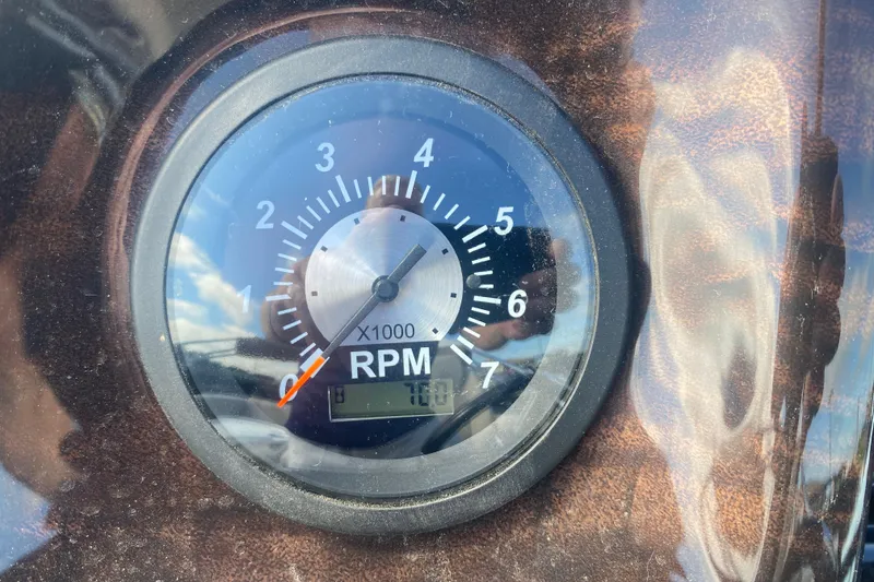 Slide: The Image of Tachometer displaying RPM in 2023 JC Swingback 27 TT Sport boat dashboard. - 21