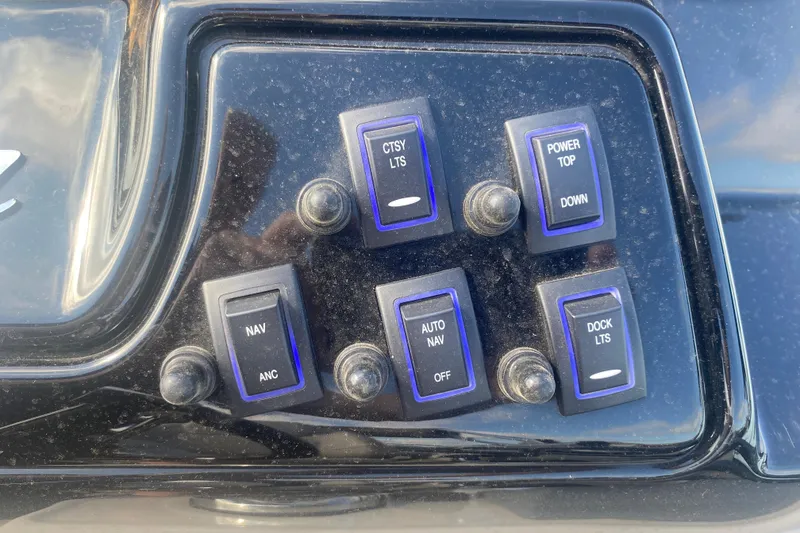 Slide: The Image of Control panel of 2023 JC Swingback 27 TT Sport with labeled switches. - 24