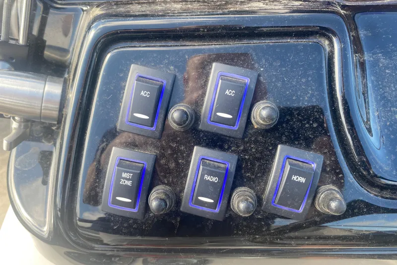 Slide: The Image of Control panel of 2023 JC Swingback 27 TT Sport with switches for accessories, radio, and horn. - 25