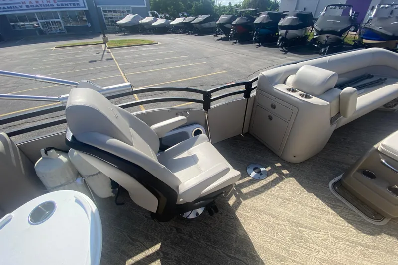 Slide: The Image of 2023 JC Swingback 27 TT Sport boat interior with seating and storage, at a boating center. - 27