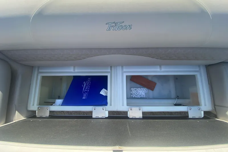 Slide: The Image of 2023 JC Swingback 27 TT Sport storage compartments with Tritoon branding and accessories. - 33
