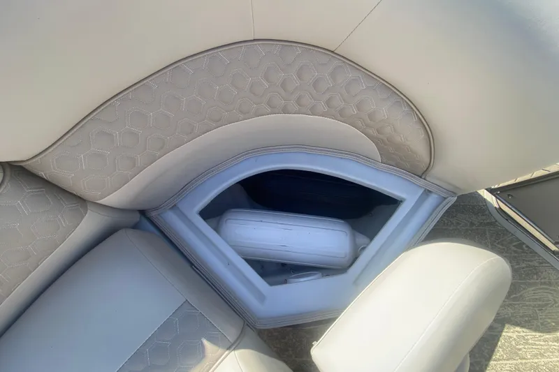 Slide: The Image of 2023 JC Swingback 27 TT Sport boat seat storage with white cushion and hexagonal pattern. - 34