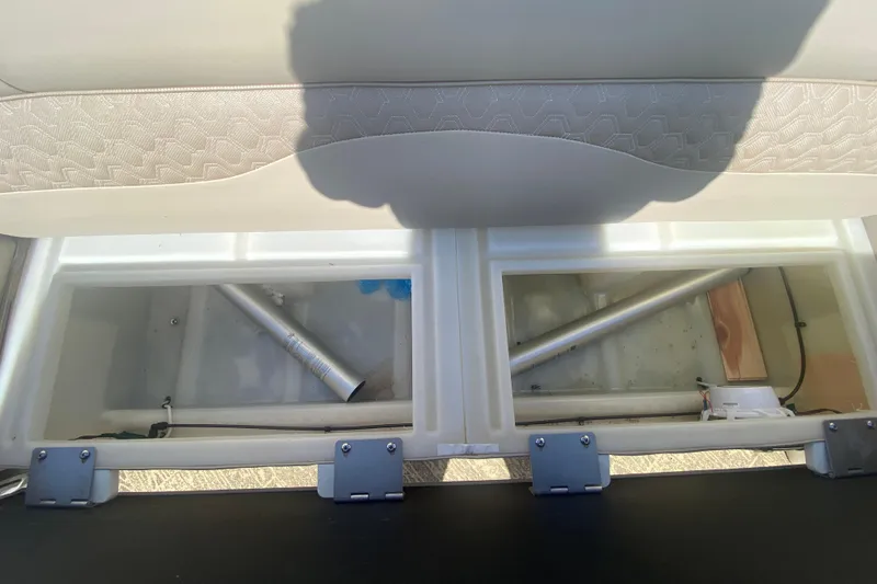 Slide: The Image of Storage compartments in a 2023 JC Swingback 27 TT Sport boat, showcasing interior design. - 36
