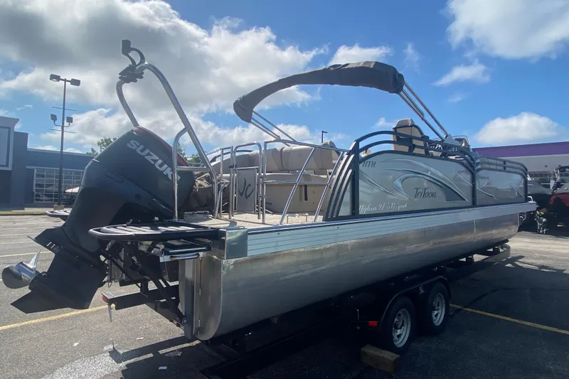 Slide: The Image of 2023 JC Swingback 27 TT Sport pontoon boat with Suzuki outboard motor on trailer. - 5