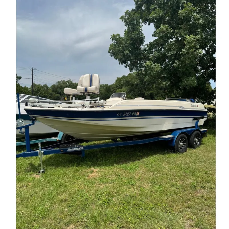 The Image of 2003 Galaxie 2100 Ultra F & S boat on trailer, parked on grass. - 0