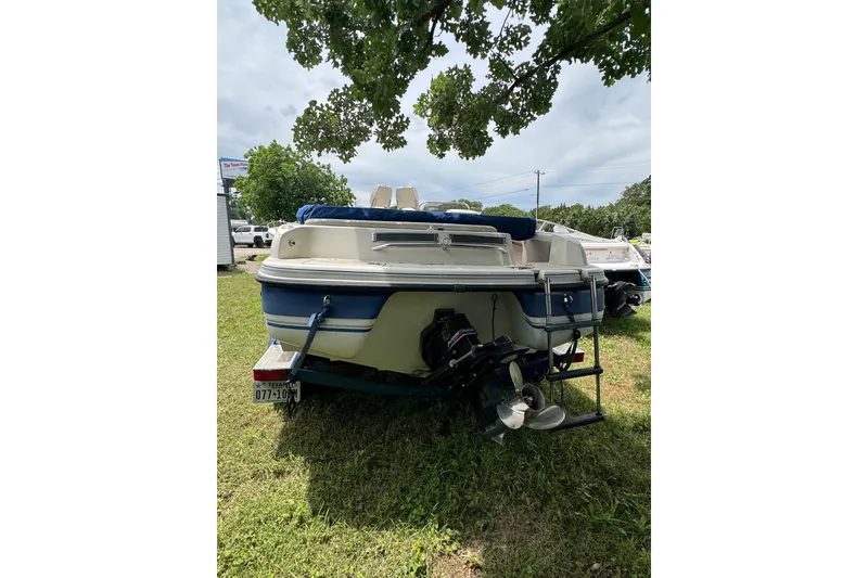 Slide: The Image of 2003 Galaxie 2100 Ultra F & S boat, rear view, parked on grass. - 3