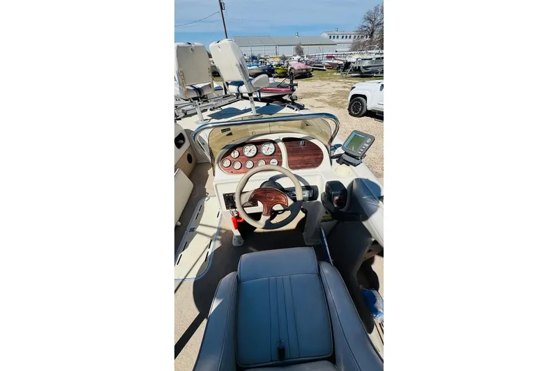 Slide: The Image of 2003 Galaxie 2100 Ultra F & S boat interior with steering wheel and dashboard controls. - 6