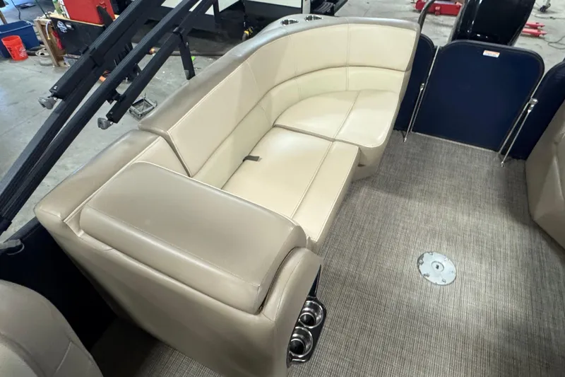 Slide: The Image of 2021 Manitou 22 Aurora LE Standard boat interior with beige seating and carpeted floor. - 11