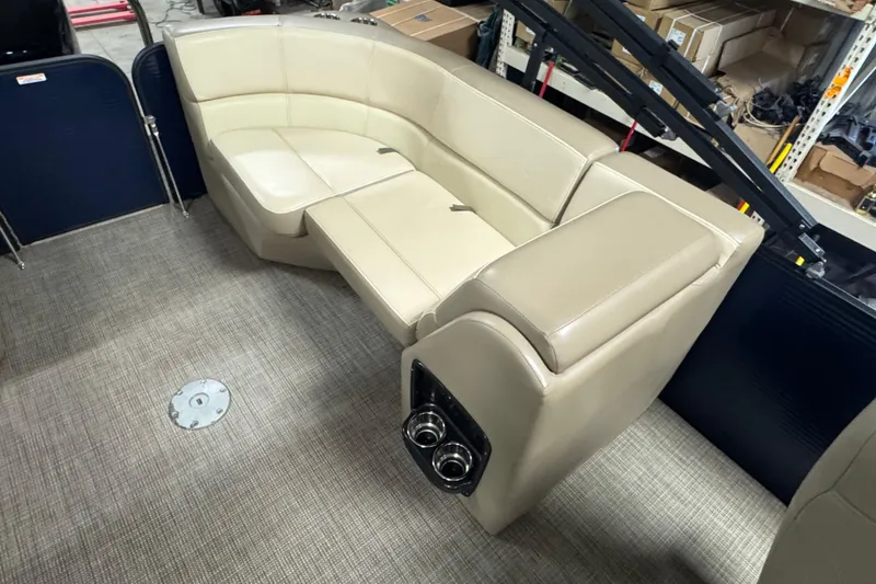 Slide: The Image of Beige seating in 2021 Manitou 22 Aurora LE Standard boat interior. - 12