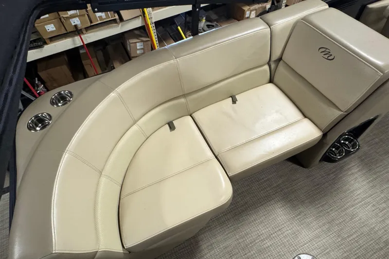 Slide: The Image of Beige seating area of 2021 Manitou 22 Aurora LE Standard boat with cup holders. - 14