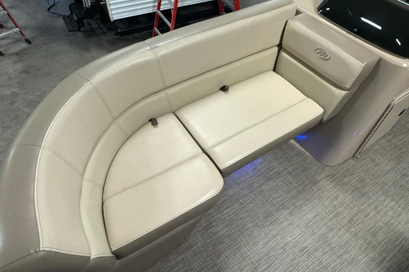 Slide: The Image of 2021 Manitou 22 Aurora LE Standard boat interior with beige seating and carpeted floor. - 5