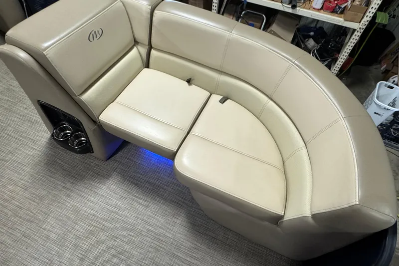 Slide: The Image of 2021 Manitou 22 Aurora LE Standard boat seating with beige upholstery and cup holders. - 6