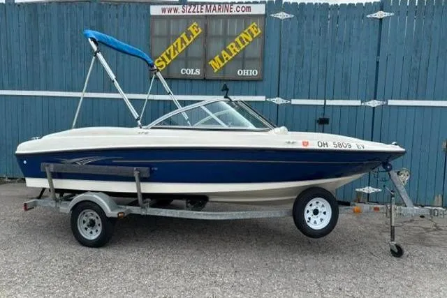 The Image of 2010 Bayliner 175 Bowrider boat on trailer, blue and white, at Sizzle Marine dealership. - 1