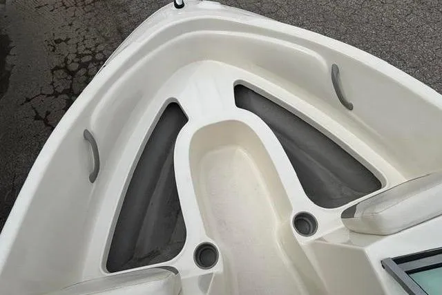 Slide: The Image of 2010 Bayliner 175 Bowrider boat interior, featuring seating and storage compartments. - 10