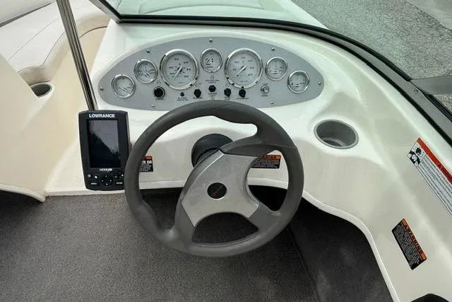 Slide: The Image of 2010 Bayliner 175 Bowrider dashboard with steering wheel and Lowrance navigation system. - 13