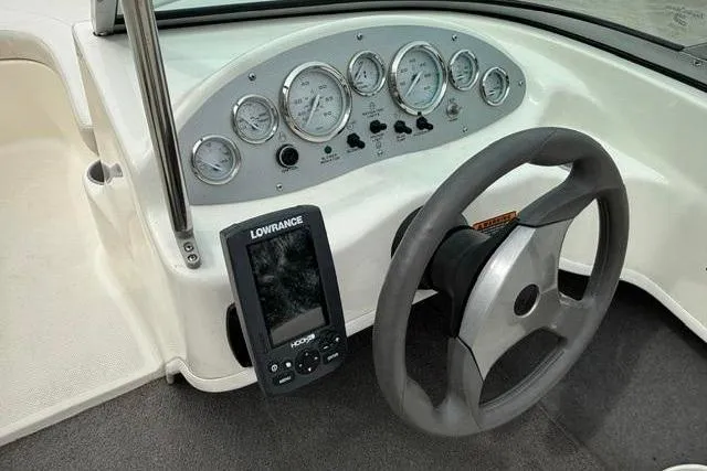 Slide: The Image of 2010 Bayliner 175 Bowrider dashboard with steering wheel and Lowrance fishfinder. - 14