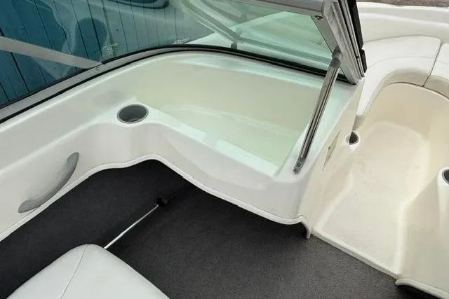Slide: The Image of Interior view of 2010 Bayliner 175 Bowrider boat, featuring seating and cup holder. - 15