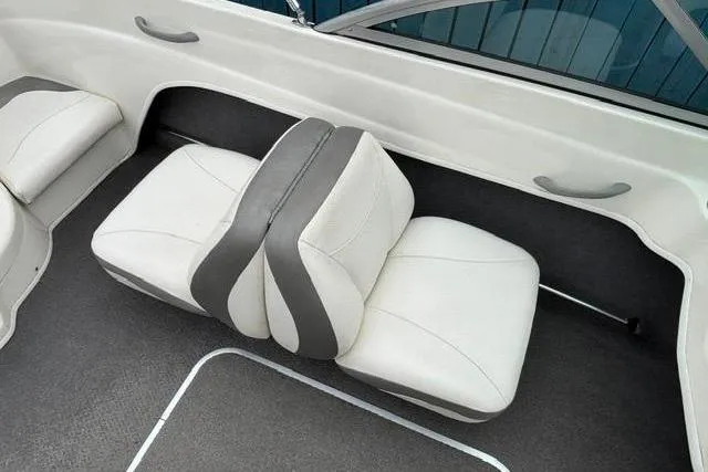 Slide: The Image of 2010 Bayliner 175 Bowrider interior with white and gray seating. - 16