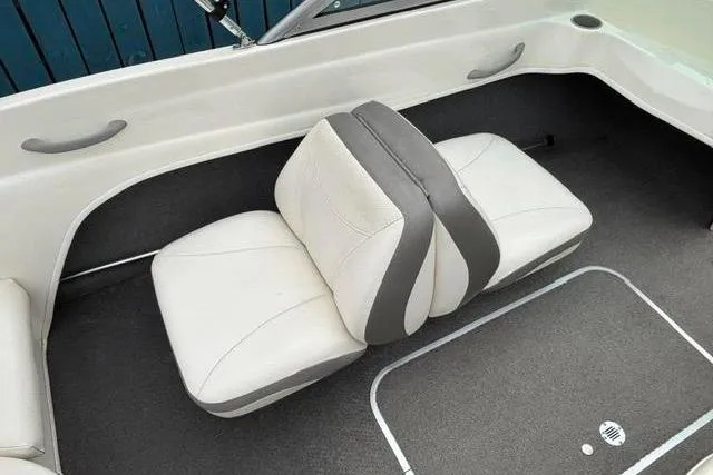 Slide: The Image of 2010 Bayliner 175 Bowrider interior with white and gray seating. - 17