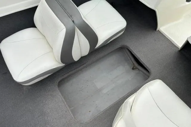 Slide: The Image of Interior of 2010 Bayliner 175 Bowrider with white seats and storage compartment. - 19