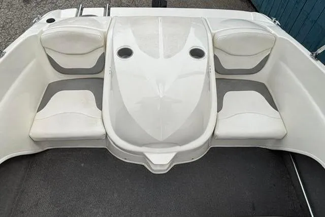 Slide: The Image of 2010 Bayliner 175 Bowrider boat interior with white seating and cup holders. - 20