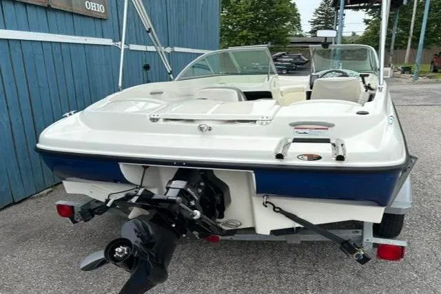 Slide: The Image of 2010 Bayliner 175 Bowrider boat on trailer, rear view, parked outdoors. - 5